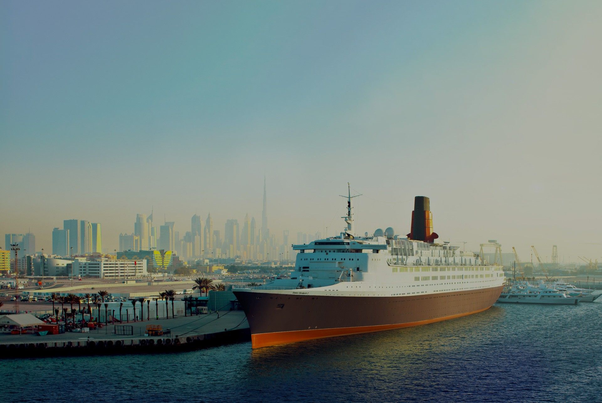 The Queen Elizabeth 2 moored at Port Rashid with the Dubai skyline behind